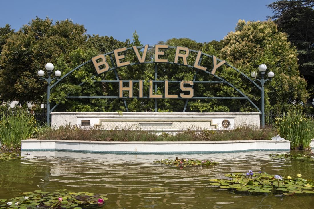 The Beverly Hills sign above a lily pond